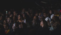 a crowd of people watching a movie at a theater