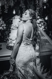 a bride posing in front of a wedding cake