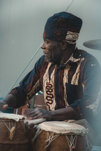 a man in a hat playing drums