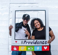 a man and woman holding up a photo frame that says providence