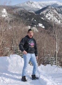 a man standing on top of a snow covered mountain